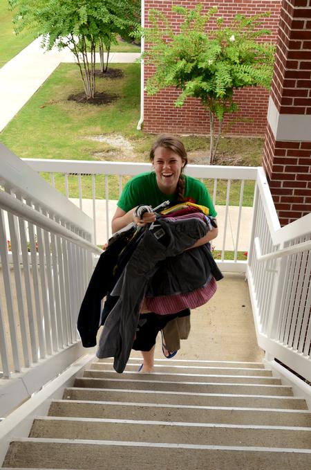 Anderson Russell, senior social work major, helps carry clothes during new student move-in day. - Photo by Anne Richoux