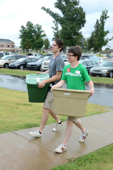 Joe Dresser, junior cell biology major, and Aaron Beasley, graduate assistant to the office of spiritual life, help move new students into their rooms during move-in day. - Photo by Anne Richoux