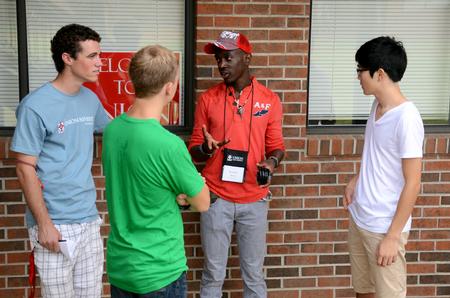 Upperclassmen students mingle with some incoming freshmen during new student move-in day. - Photo by Anne Richoux