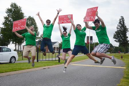 Kensie Zills, Nick Fleming, Emily Williams, Hillarie Kerr, and Robert Fryman enthusiastically welcome new students and their families during move-in day. - Photo by Zac Calvert