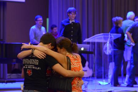 The Smithwick family prays together after worshipping during a chapel service following new student move-in. For many students, this time is filled with excitement for the future and mixed emotions over leaving families at home. - Photo by Jacob Moore