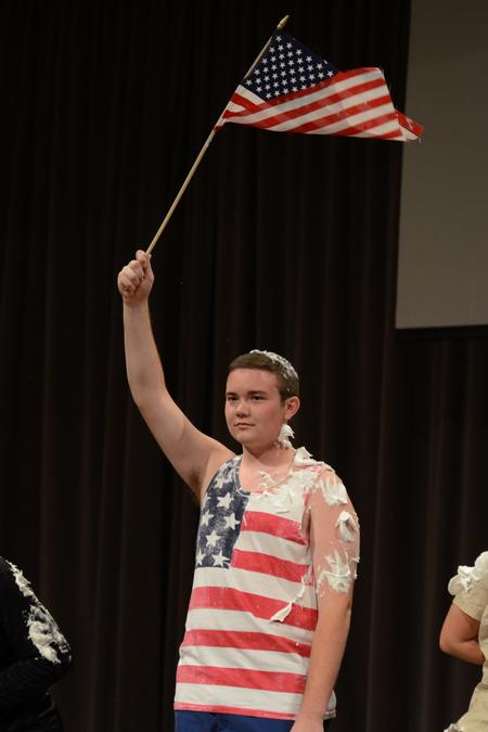Focus leader Wil Story portrays a flagpole in one of the skits performed for the incoming freshmen and transfer students at the Focus Show. - Photo by Jacob Moore