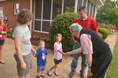 David S. Dockery, president of the university, greets Tim Ellsworth, assistant vice president for university communications and director of media relations, Sarah Ellsworth and their children at the ice cream social hosted for new students. - Photo by Morris Abernathy