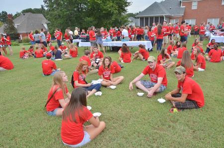 Over 300 new students enjoy an ice cream social on the lawn of David and Lanese Dockery, president and first lady of the university. - Photo by Morris Abernathy