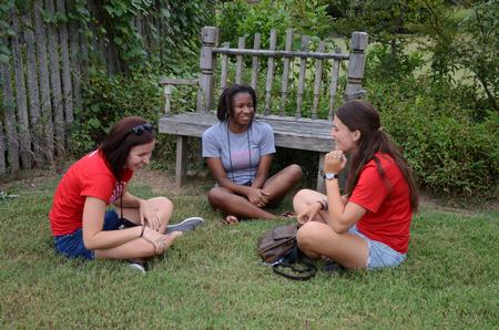 Liz Bankston, junior vocal performance major, Amber Buggs, freshman education major, and Karis Kontilis, freshman art and English double major, laugh together during the annual ice cream social at the home of the Dockerys.  - Photo by Anne Richoux