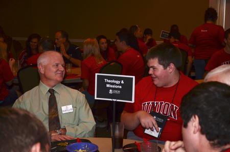Randall Bush, professor of Christian thought and tradition, talks about the School of Theology & Missions to Reeves Garrett, freshman biblical studies major, during Dinner with you Department. - Photo by Zac Calvert