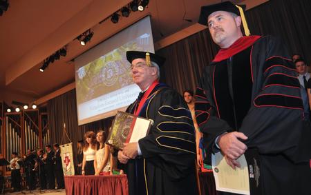 David S. Dockery, president of the university, and Todd Brady, vice president of spiritual life, watch as the faculty of Union University enter the George M. Savage Memorial Chapel for Fall Convocation. - Photo by Morris Abernathy