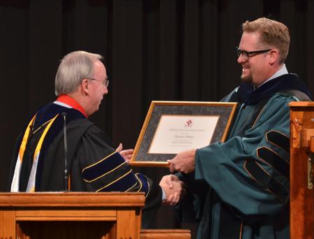 David S. Dockery, president of the university, installs Hunter Baker as the Dean of Instruction during Fall Convocation. - Photo by Morris Abernathy