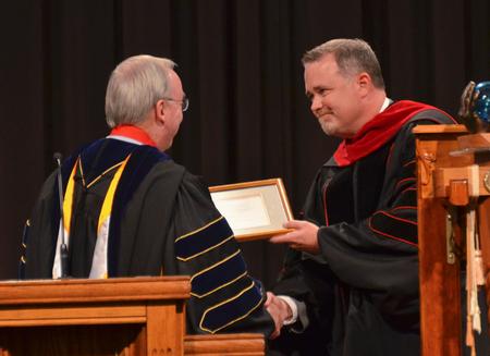 David S. Dockery, president of the university, installs Todd Brady as the  new vice president for church relations during Fall Convocation. - Photo by Morris Abernathy