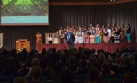 Chris Mathews, associate professor of music and department chair, leads the University Singers during Fall Convocation. - Photo by Morris Abernathy