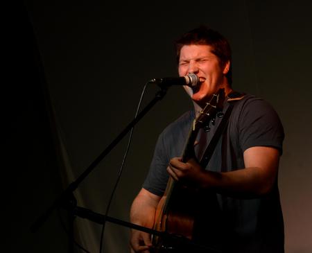 John Monroe, freshman psychology major, hits a high note while singing "Free Fallin'" during the Focus weekend Open Mic Night.  - Photo by Ebbie Davis