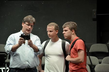 Chris Blair, professor of communication arts, demonstrates to his students how to use the new iPhone videography app. - Photo by Ebbie Davis