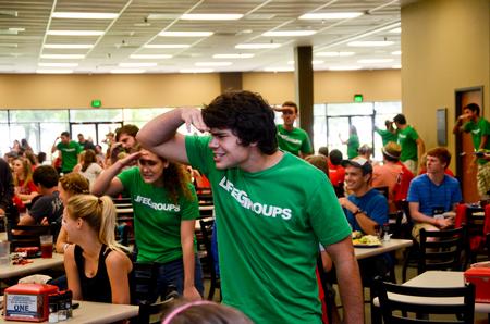 Taylor Hare, junior English major, along with his fellow LifeGroup leaders, participates in a flash mob in the Brewer Dining Hall during new student orientation. - Photo by Ebbie Davis