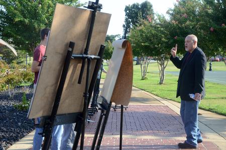 Chris Nadaskay, university professor of art, instructs his drawing students to focus on the negative space while sketching the trees on campus.  - Photo by Ebbie Davis