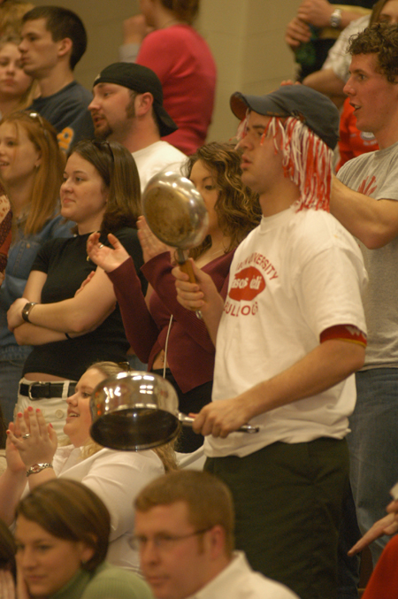 Freshman Landon Preston leads fans in noisy cheers during the Homecoming basketball games.  - Photo by Lindsay Stavish