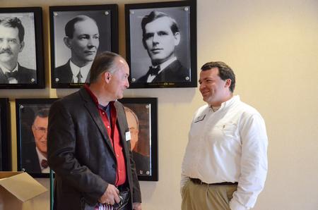 Jerry Tidwell, senior vice president for university relations, talks with Josh Clarke, director of alumni relations, outside the Carl Grant Event Center during the President's Brunch. - Photo by Zac Calvert