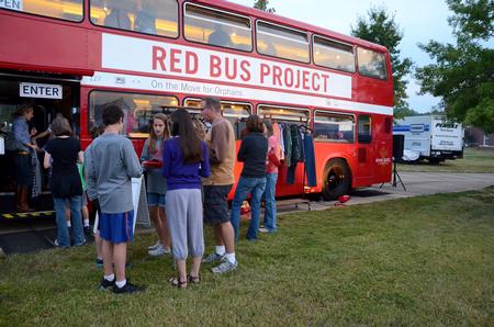 Family members and students stand in line to shop for clothing from the Red Bus Project at Union Night during Family Weekend. - Photo by Anne Richoux