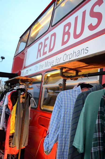 Students and families had the opportunity to take part in the Red Bus Project by donating or shopping for clothes on the big red bus at Union Night during Family Weekend. - Photo by Anne Richoux