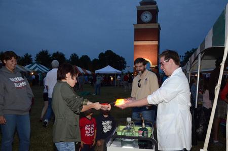 Chase Bouchillon, junior chemistry major, watches and laughs as Elisabeth McWhorter, sophomore chemistry major, sets propane bubbles in his hands on fire at Union Night during Family Weekend. - Photo by Anne Richoux