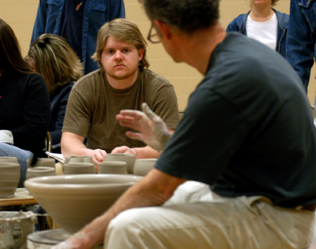 Junior Robert Alsobrook pays close attention to artist Chris Staley during a ceramics workshop. - Photo by Jonathan Blair