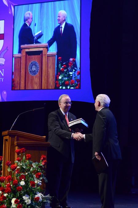 David S. Dockery, president of the university, gives a Bible and a book about the history of Union to Robert M. Gates, former U.S. secretary of defense, during the 15th Annual Scholarship Banquet.  - Photo by Jacob Moore