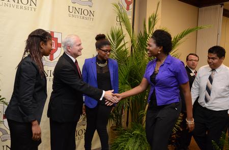Desirae Suggs, senior business administration major, greets Robert M. Gates, former U.S. secretary of defense, after the 15th Annual Scholarship Banquet. - Photo by Jacob Moore
