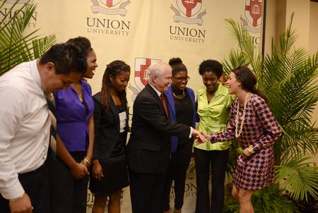 Claudia Velasco, senior accounting major, and friends greet Robert M. Gates, former U.S. secretary of defense, after the 15th Annual Scholarship Banquet. - Photo by Jacob Moore