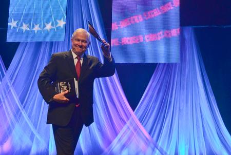 Robert M. Gates, former U.S. secretary of defense,  waves farewell to the audience at the 15th Annual Scholarship Banquet. - Photo by Morris Abernathy