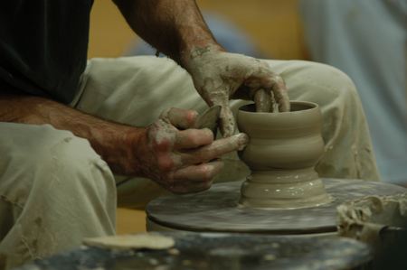 The hands of Chris Staley work on a piece during a ceramics workshop held on Union's campus. - Photo by Jonathan Blair