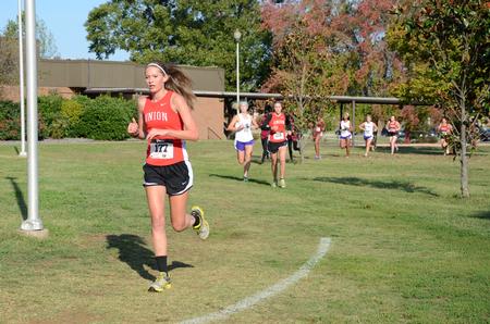 Anna McKelvey, freshman English major, runs in the Union University Cross Country Invitational. The women's cross country team came in first place in their event.  - Photo by Anne Richoux