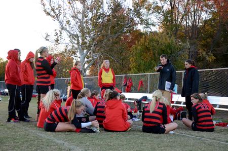 Head coach Isaac Brooks talks with the Lady Bulldogs during their last home soccer game of the season.  - Photo by Anne Richoux