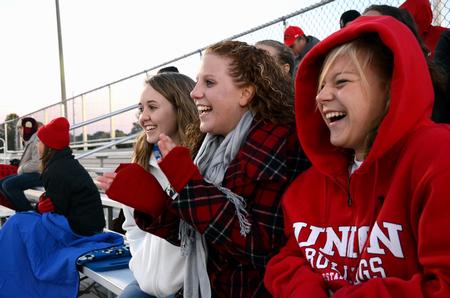 Shelby Evans, senior nursing major, Kara Kitchens, senior athletic training major, and Reagan Schrader, freshman accounting major, cheer for the Lady Bulldogs during a home soccer game against Cumberland University.  - Photo by Anne Richoux