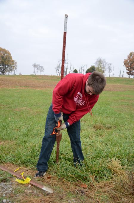 Kenan Keller, junior history major, helps clean the grounds of Parker's Crossroads Battlefield in Henderson County during the tenth annual Campus and Community Day. - Photo by Jacob Moore