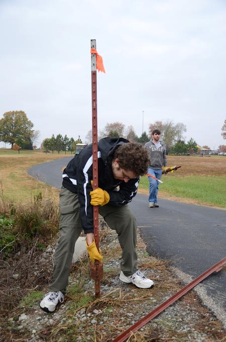 Lowell Van Ness, senior history major, works with the history department on the grounds of Parker's Crossroads Battlefield in Henderson County during Campus and Community Day. - Photo by Jacob Moore