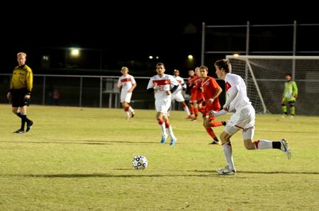Clayton Martin runs to keep possession of the ball in a game against Tennessee Temple University during the semifinal round of the NCCAA mideast region tournament. Union won the game 8-0.  - Photo by Anne Richoux