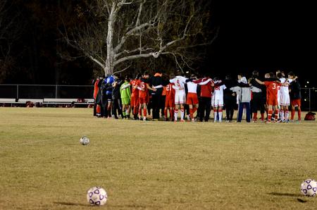 The Bulldog soccer team huddles with the Tennessee Temple University team following their semifinal round game for the NCCAA mideast region tournament. - Photo by Anne Richoux