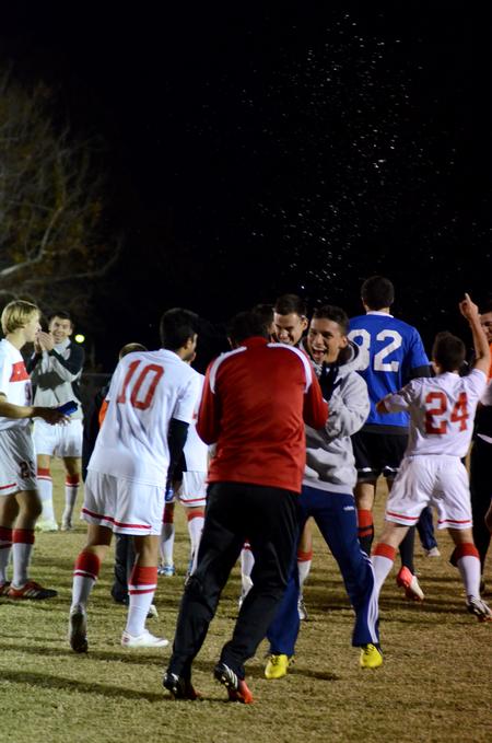 Brian Castro celebrates with the Bulldog soccer team after their semifinal round win in the NCCAA mideast region tournament. - Photo by Anne Richoux