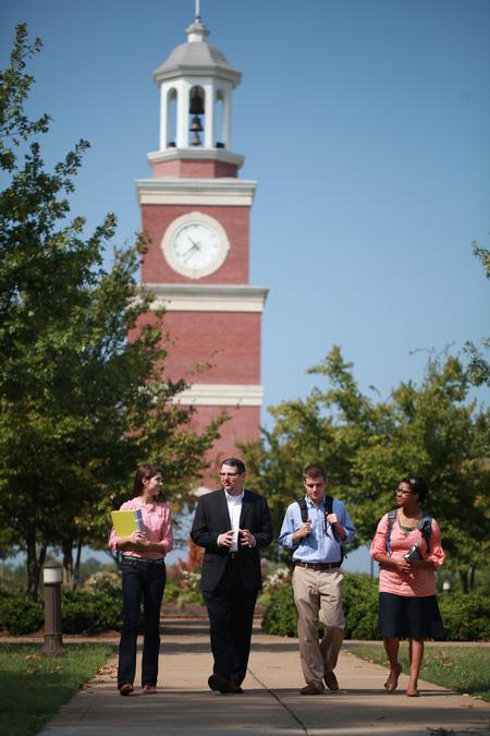 Keith Bates, associate professor of history, walks toward the P.A.C. with a group of students.  - Photo by Kristi McMurry Woody