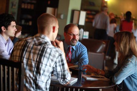 Scott Huelin, associate professor of English and director of the honors community, meets with several students in Barefoots Joe. - Photo by Kristi McMurry Woody