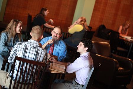 Scott Huelin, associate professor of English and director of the honors community, talks with a group of students in Barefoots Joe. - Photo by Kristi McMurry Woody