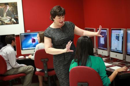 Ashley Blair, assistant professor of communication arts, talks with students in the publication lab. - Photo by Kristi McMurry Woody