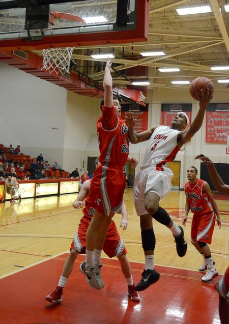 Bulldog AJ Roberts goes up for a shot against Christian Brothers' Michael Drake during a home game. - Photo by Jacob Moore