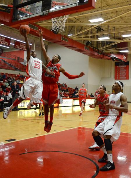 Bulldog Corieon Pearson goes up for a shot against Christian Brothers' Drew Hildreth during a home game. Union narrowly won 73-70. - Photo by Jacob Moore