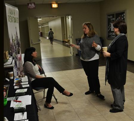 Faculty members and students discuss different study abroad options at the external study fair.  - Photo by Olivia Wallace