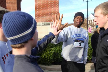 Business administration majors Bangali Sillah and Daniel Roberts high five before beginning the Chi Omega 5K during Homecoming weekend. - Photo by Matt McDaniel