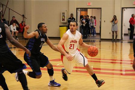Pedro Faller dribbles past a Hawks defender for a lay up.  - Photo by Matt McDaniel