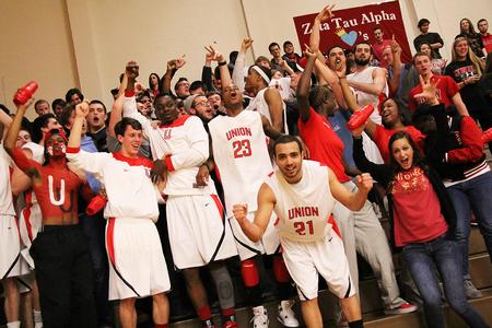 Pedro Faller and his teammates celebrate their homecoming victory over the Shorter University Hawks with all of the fans that came out to support them. - Photo by Matt McDaniel