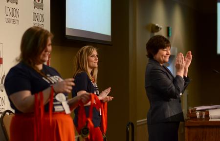 Along with students Kathryn Moore and McKenzie Masters, Ashley Blair, assistant professor of communication arts, applauds the overall winners of the Onsite Competition during the Southeastern Journalism Conference held at Union. Blair served as the 2013 president. - Photo by Jacob Moore