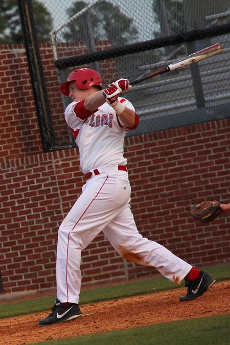 Kody Pinson singles up the middle scoring a run for the Bulldogs in the game against the Freed-Hardeman Lions. - Photo by Matt McDaniel
