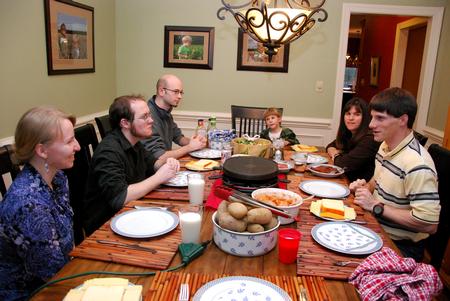 Grace Morriss, junior engineering major, Ryan Harris, freshman engineering major, and Ward Howard, physics and math double major, enjoy dinner with Georg Pingen (right), assistant professor of engineering, and his family as a part of SAC's Be Our Guest. - Photo by Anne Richoux